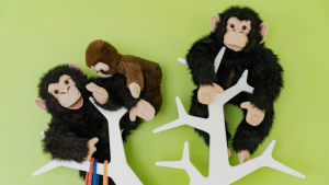 Unsere Stoffaffen Charlie und Jonny, die auf einer weißen Kleiderstange in Form eines Baumes sitzen